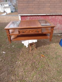 Solid wood coffee table with glass pops.
