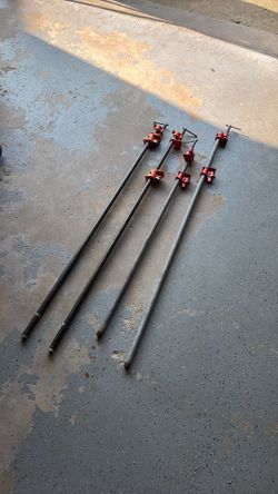 4 heavy-duty cast-iron pipe clamps used for woodworking projects like gluing.  2 are Jorgensen.