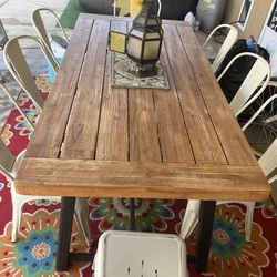 Outside farm wood table and chairs and colorful outside rug included
