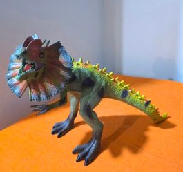 Dilophosaurus Dinosaur Toy Figure Detailed Dilophosaurus figure has green and yellow textured skin with dark spots.  Toy is made of durable hard plast