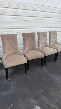 4 Brown dining chairs.