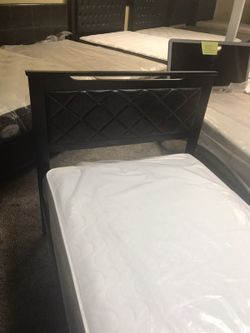 Twin wooden bed with leather headboard