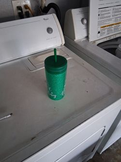 A Christmas Cup With A Straw And Lid