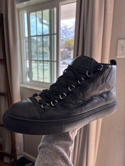 Balenciaga Arena high-top sneakers, crafted from black wrinkled lambskin leather with signature silver-tone D-ring eyelets