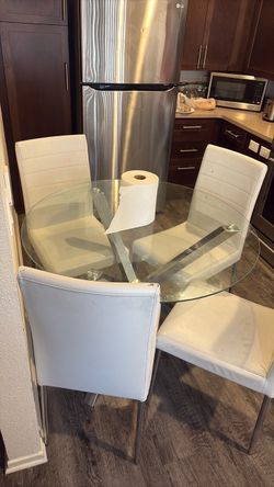 Glass table with 4 white chairs