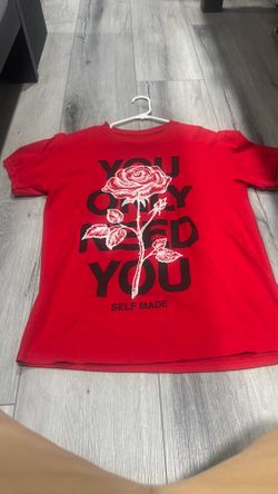 red graphic t-shirt featuring a large central rose design layered over bold text.