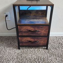 Rustic Style Metal and Wooden Nightstand/End Table with Shelf, Fabric Drawers, Charging Station and LED Lights