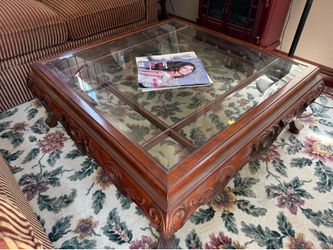 beveled glass and ornate carved square coffee table.