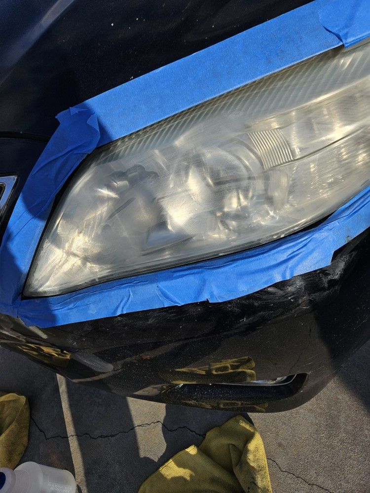 Renewed headlights and windshield with water Spots.