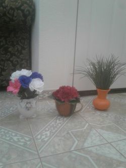 Artificial flowers in pot. Asking $5 each