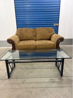 Brown couch and glass top coffee table set
