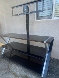 3-in-1 flat panel TV stand with a black tempered glass finish and integrated swivel mount