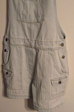 A pair of denim overalls with pockets