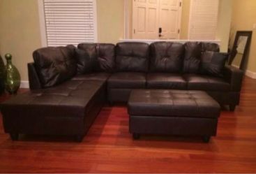 Brown leather sectional couch and ottoman