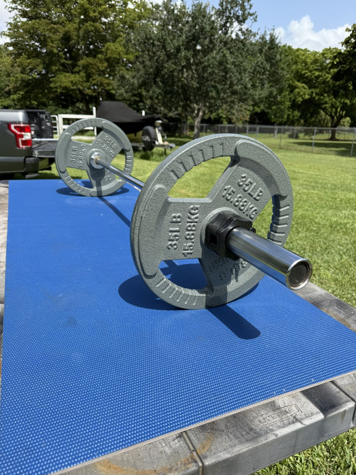 Set Including 5’ Olympic Bar And Pair Of 35 Pound Easy Grip Weights