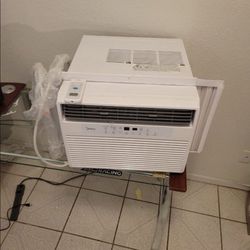 Large window air conditioner with Bluetooth capabilities and a remote. 