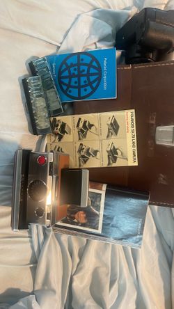 Vintage Polaroid sx-70 land camera with case and booklets