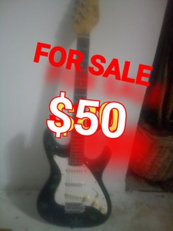 Black guitar with pot leaves on it$50