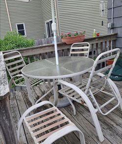 Patio Dining Set: 4 Vinyl Strap Chairs, 2 Vinyl Strap Ottomans, large Glass Table and Crank Umbrella