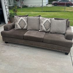 Brown Couch With Deco Pillows