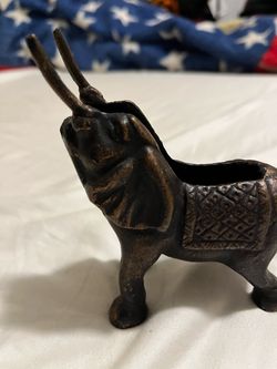 vintage bronze elephant figurine with an open cavity on its back