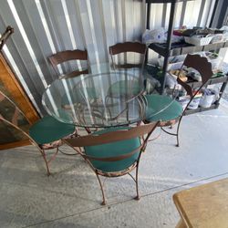 Shaver-Howard Dining Set With Heavy Beveled Glass Top And 5 Cushioned Chairs. All On Wrought Iron