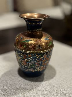 Vase featuring floral designs. Measures 7”