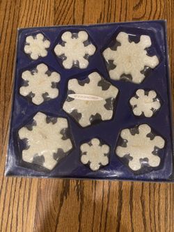 Set of nine snowflake shaped floating candles