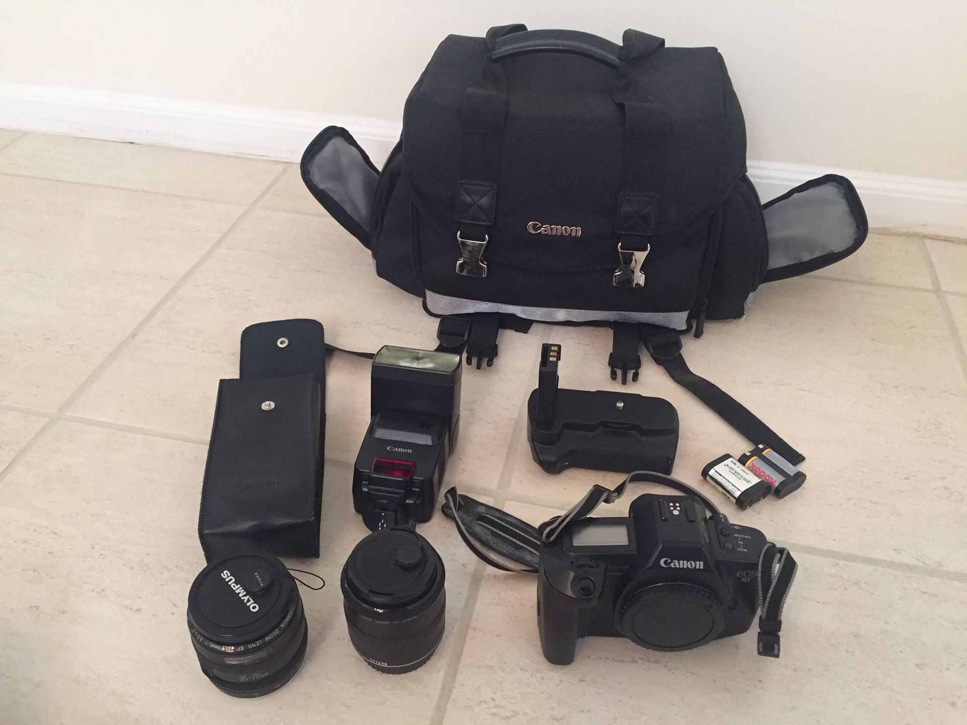 Canon EOS RT film camera with 2 lenses, extra life battery pack, camera case, 2 lithium batteries, and a speedlite 430 EZ light