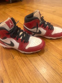 Nike Jordan baseball cleats in a red