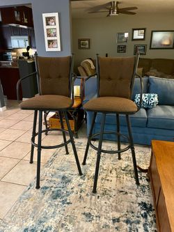 2 brown fabric bar stools, black metal frame