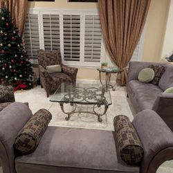 Purple suede couches and Mauve chairs and 2 glass tables