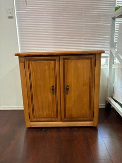 Wooden two door Cabinet on caster wheels
