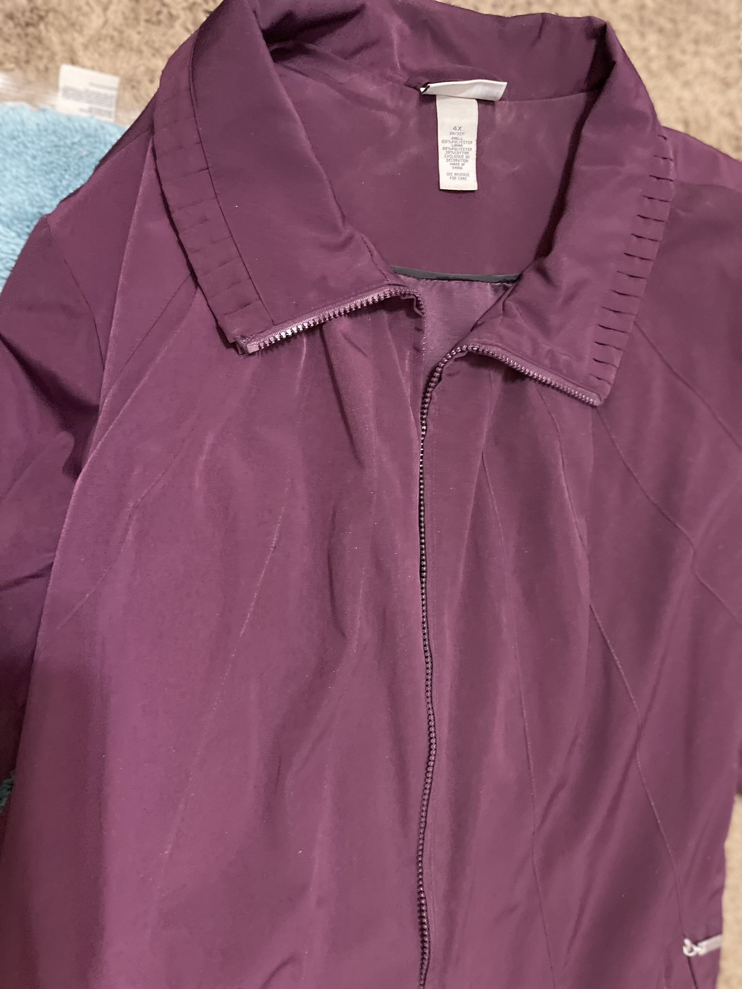 beautiful maroon coat complrtely lined, zip front,with pleated detail on the collar sleeve bottom