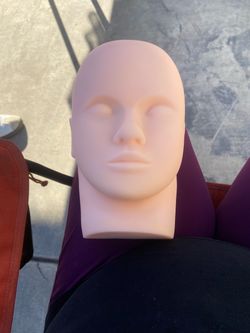 Face for practicing makeup and eyelashes—one new and one used.