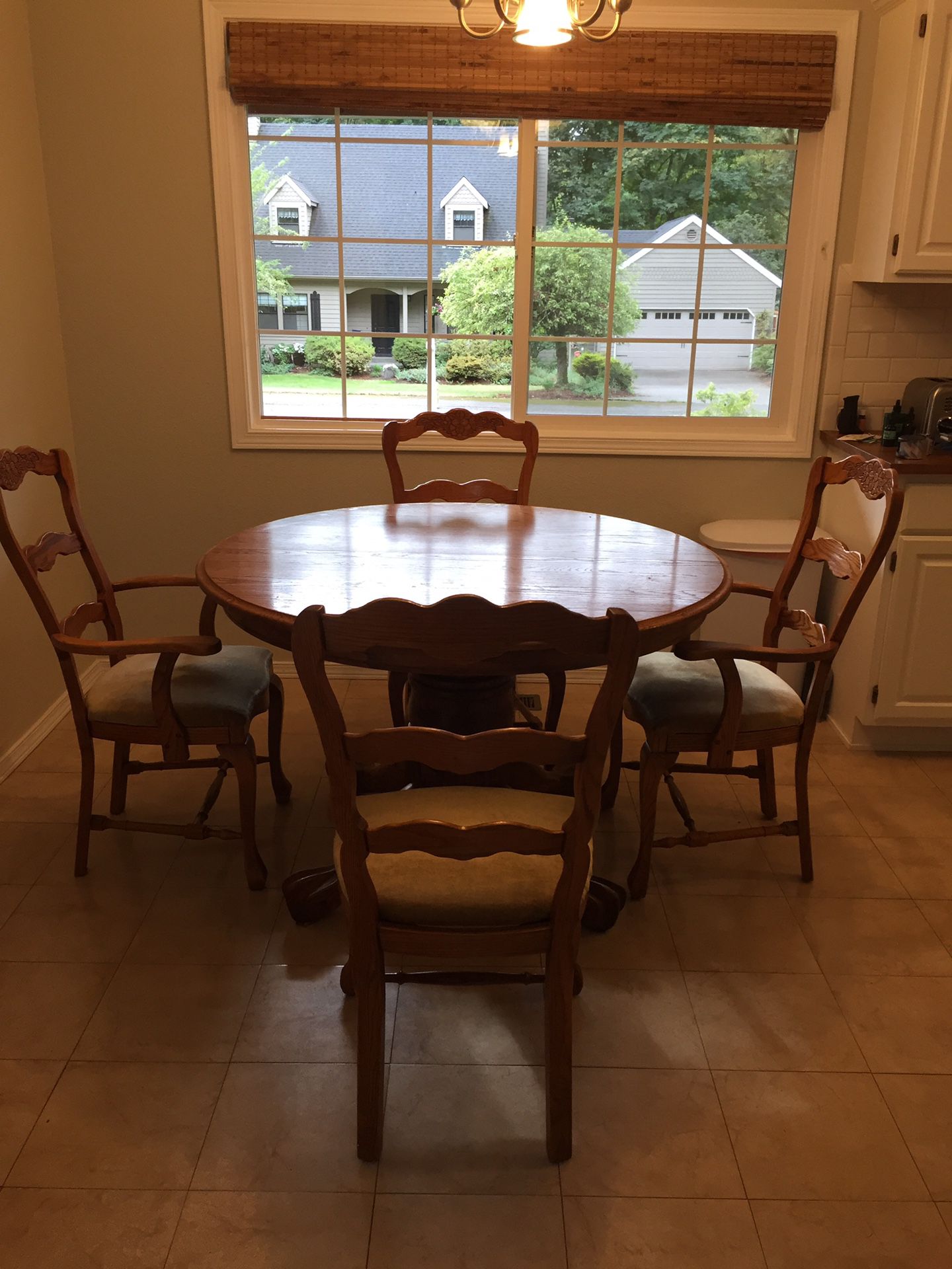 Solid oak kitchen or dining room table with 6 chairs and leaf. Diameter is 48”. Height is 32” and the leaf is 24” x 48”.