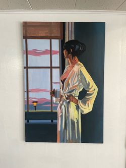 Woman with coffee cup at window