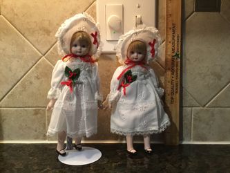 Two Porcelain Holiday Dolls and One Doll Stand
