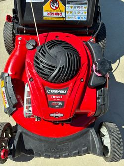 Like new Troy Bilt push lawnmower only used five or six times starts right up runs perfect.
