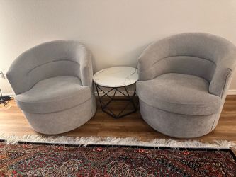 Two gray swivel chairs