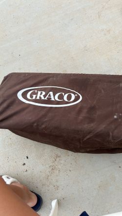 brown Graco Pack 'n Play portable playard