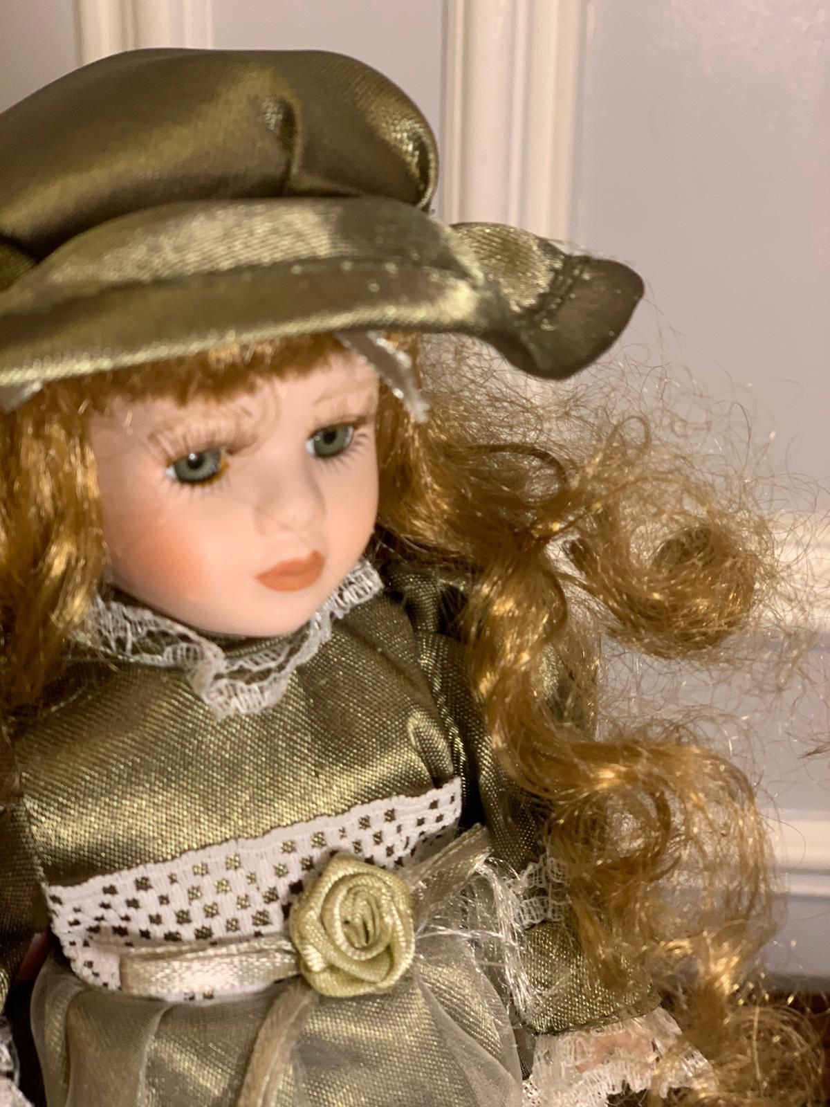 9” Porcelain Doll Dressed In An Olive Color Dress With Lace Detail
