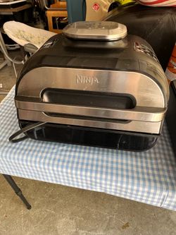 Ninja Foodi Smart XL 6-in-1 Indoor Grill, featuring a stainless steel front panel.