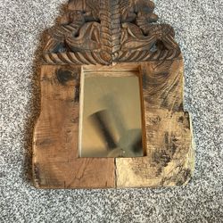 carved wood hanging mirror