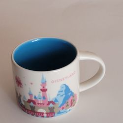 Starbucks You Are Here Collection 14oz mug Disneyland with a pink castle 
and blue interior. Pre-owned, very good shape, please see the photos.
It is 