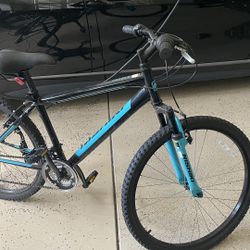 Used black and teal Nishiki Pueblo 26" Men's Mountain Bike designed for trail riding