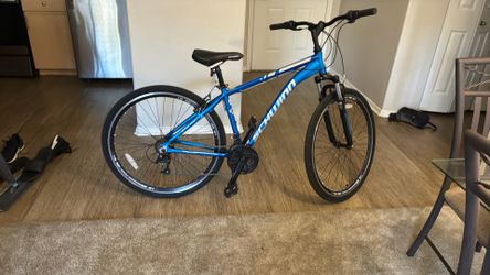 This is a blue Schwinn GTX 3 hybrid bicycle.