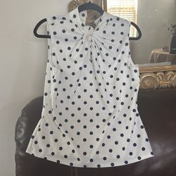 white sleeveless blouse with black polka dots