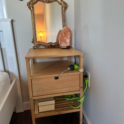 wooden nightstand and gold mirror