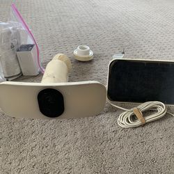 Used Arlo Pro 3 Floodlight Wireless 2K Outdoor Camera, battery, Arlo solar panel, and gutter mount